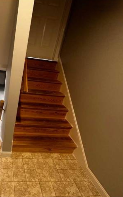 Staircase with old hardwood before renovation