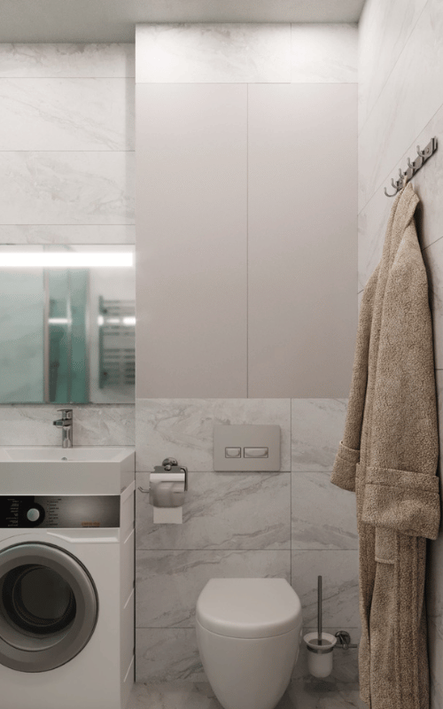 Experience modern elegance with a bathroom that combines functionality and style. Featuring sleek marble-patterned tiles, clean lines, and an integrated washing machine for smart living.